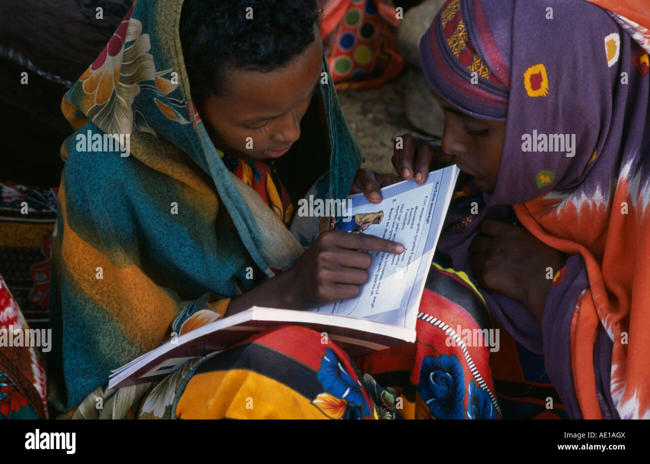 SOMALIA  Horn Of Africa People Baidoa girls reading school text books produced by UNICEF Stock Photo