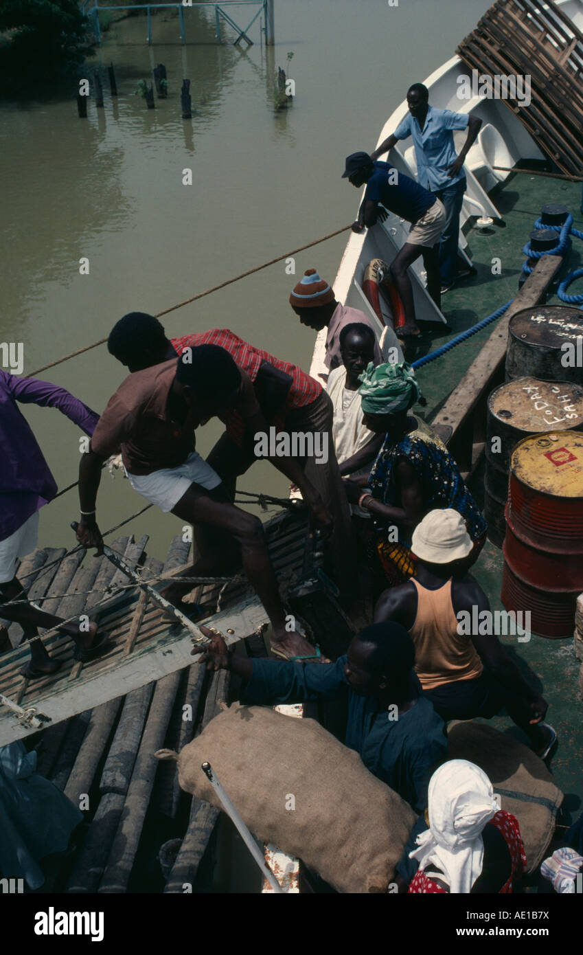 GAMBIA West Africa People boarding boat on the River Gambia by ...