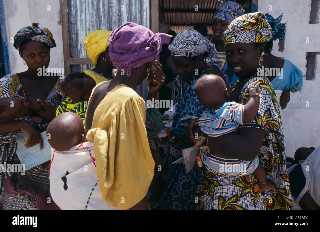GAMBIA West Africa Medical Women and children queuing outside rural health clinic Stock Photo