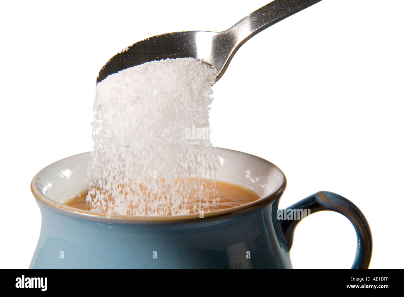 Pouring sugar from silver spoon into cup of hot English tea on saucer Stock  Photo - Alamy, image size:1300x956
