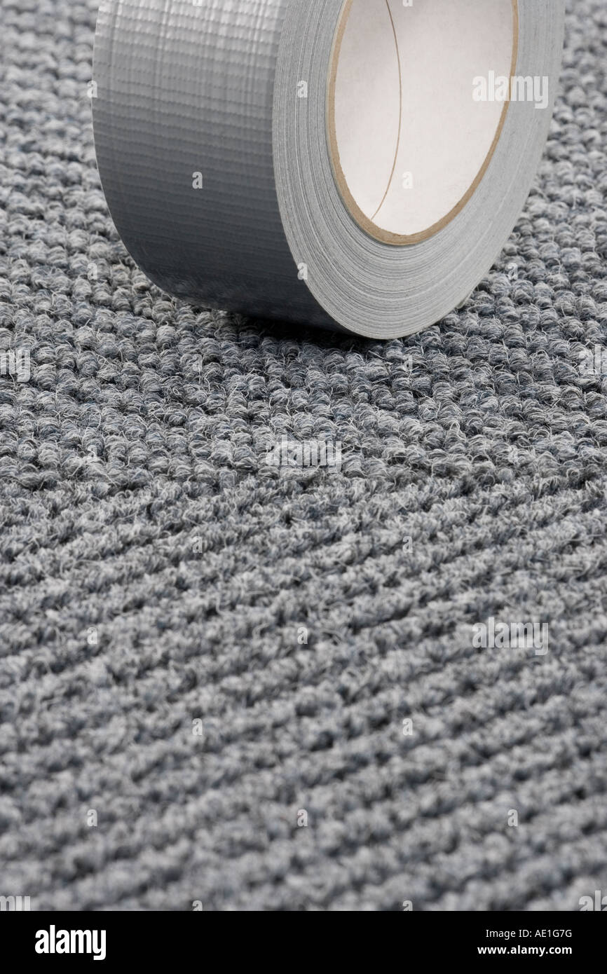 Roll of Gaffer tape on patterned carpet tile floor Stock Photo