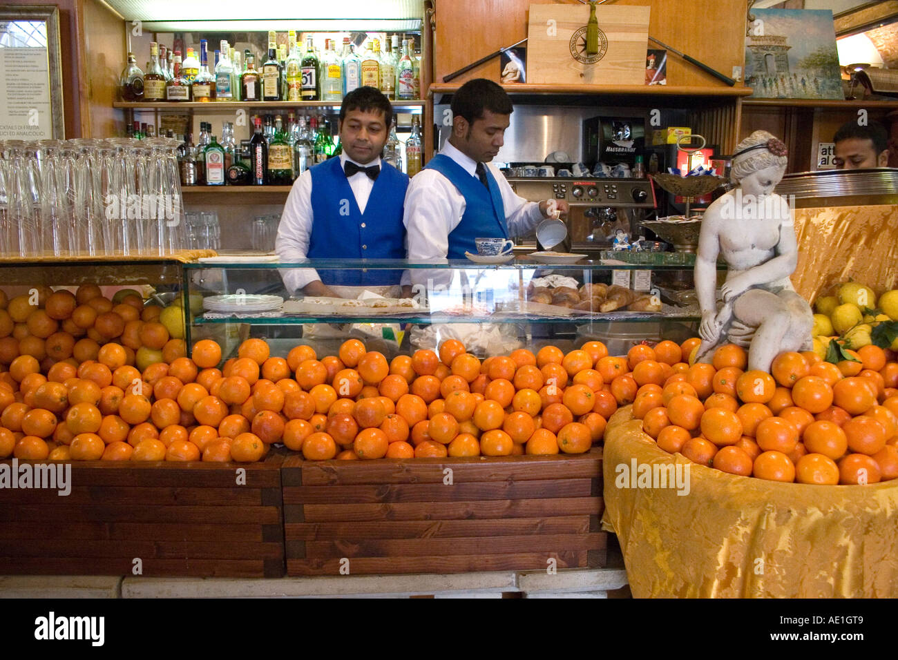 Cafe in Rome Italy with oranges and Waiters in blue uniforms Stock