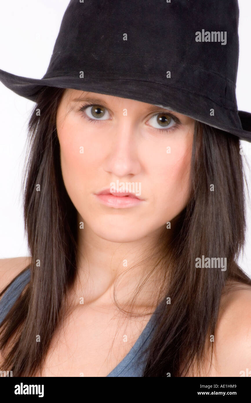 Beautiful Young Irish woman with black hair and blue eyes wearing a black hat Stock Photo