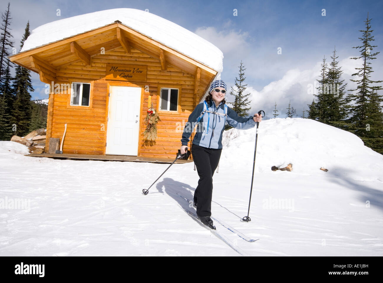 A woman cross country skiing past a warming hut at Silver Star near