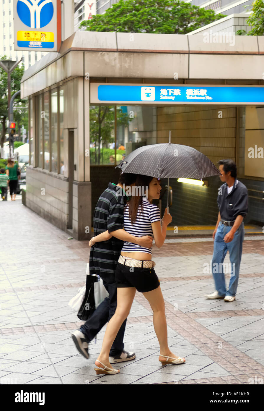 Young couple walking in the rain, Yokohama Stock Photo