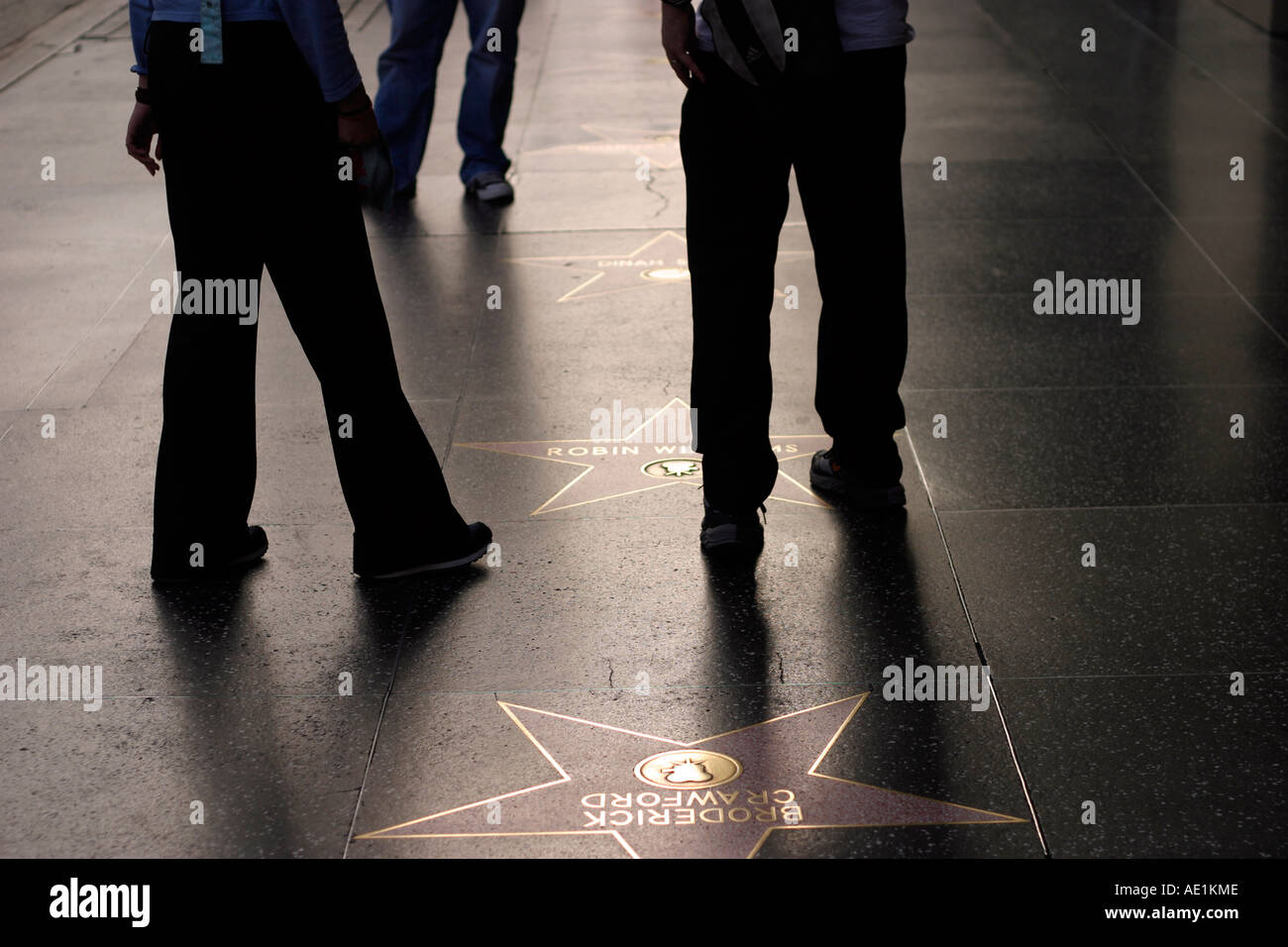 Tourists walking by Robin Williams star at the Walk of Fame Hollywood ...