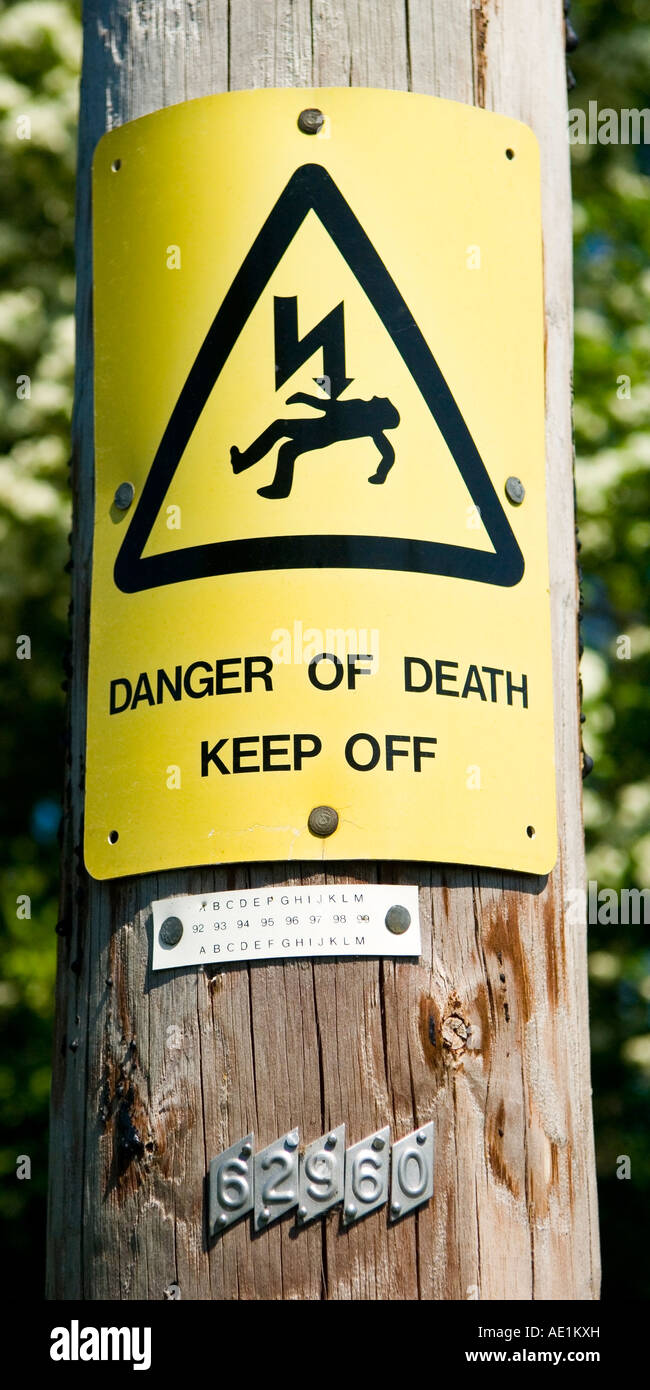 Danger of death Keep off sign onelectrical pole in the countryside Surrey England UK Stock Photo