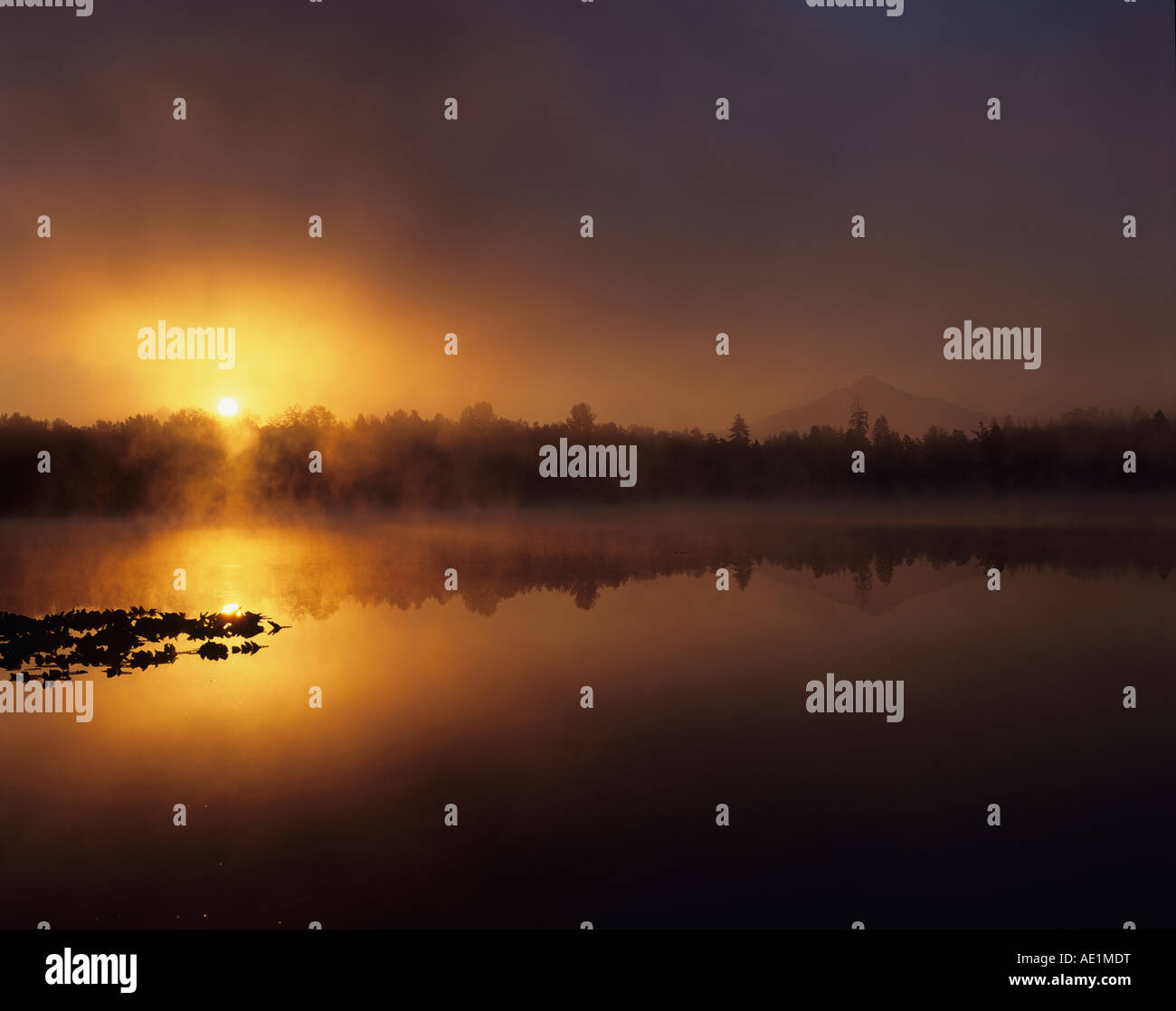Dramatic sunrise over Lake Cassidy with Mount Pilchuck with early