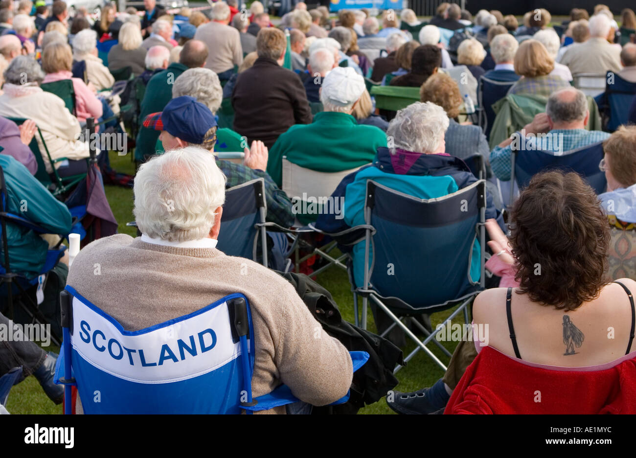 Orchestra performers on Stage,  crowds and audience at Balmoral Castle Musical Concert evening, Aberdeenshire, Scotland uk Stock Photo