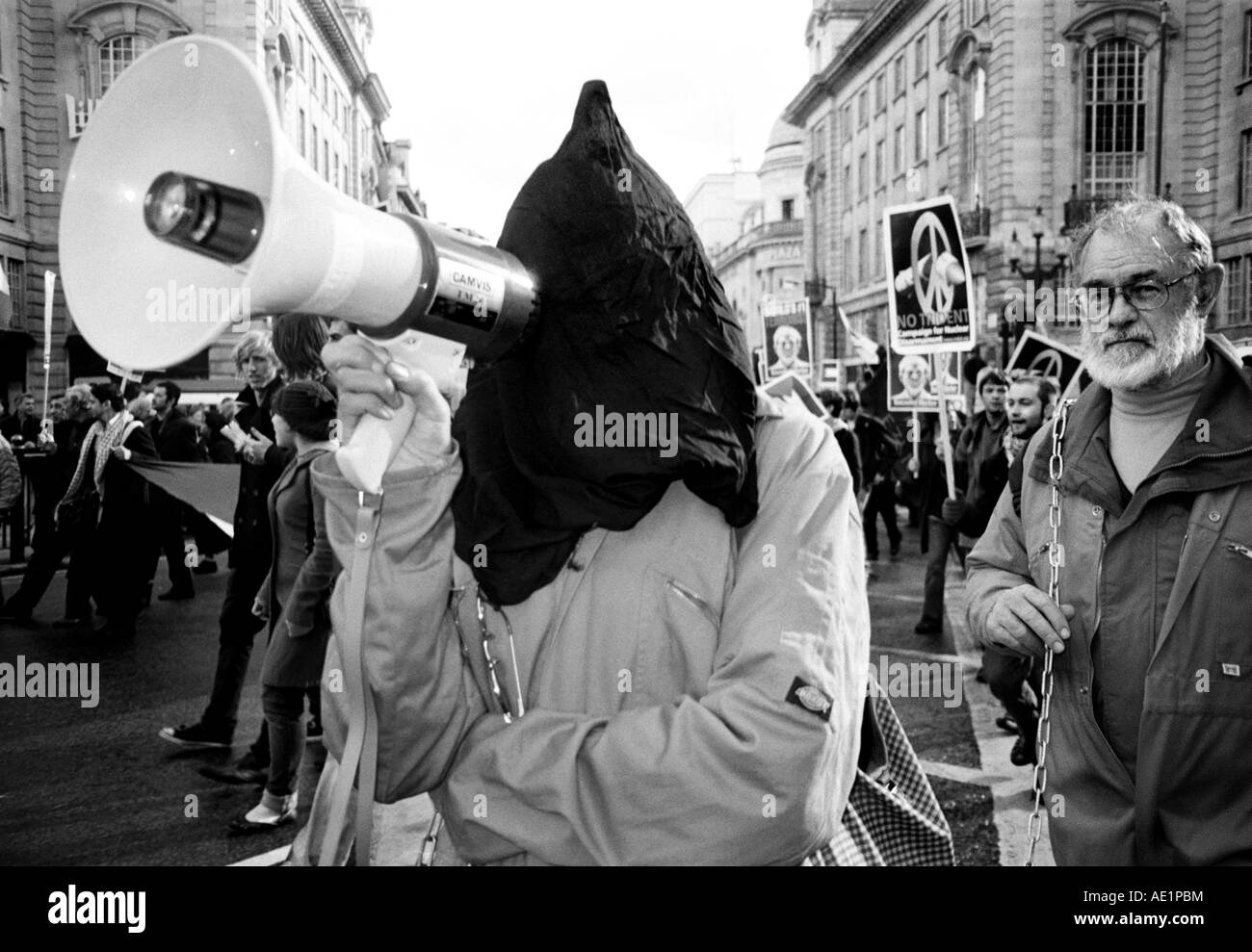 Anti Guantanamo Bay protestors walk along Piccadilly Circus during an anti Iraq war march in London UK Stock Photo