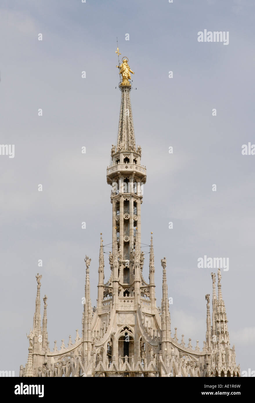 Spire of Duomo di Milano, the Milan Cathedral, from the roof, with the golden Madonna statue, La Madunina Stock Photo