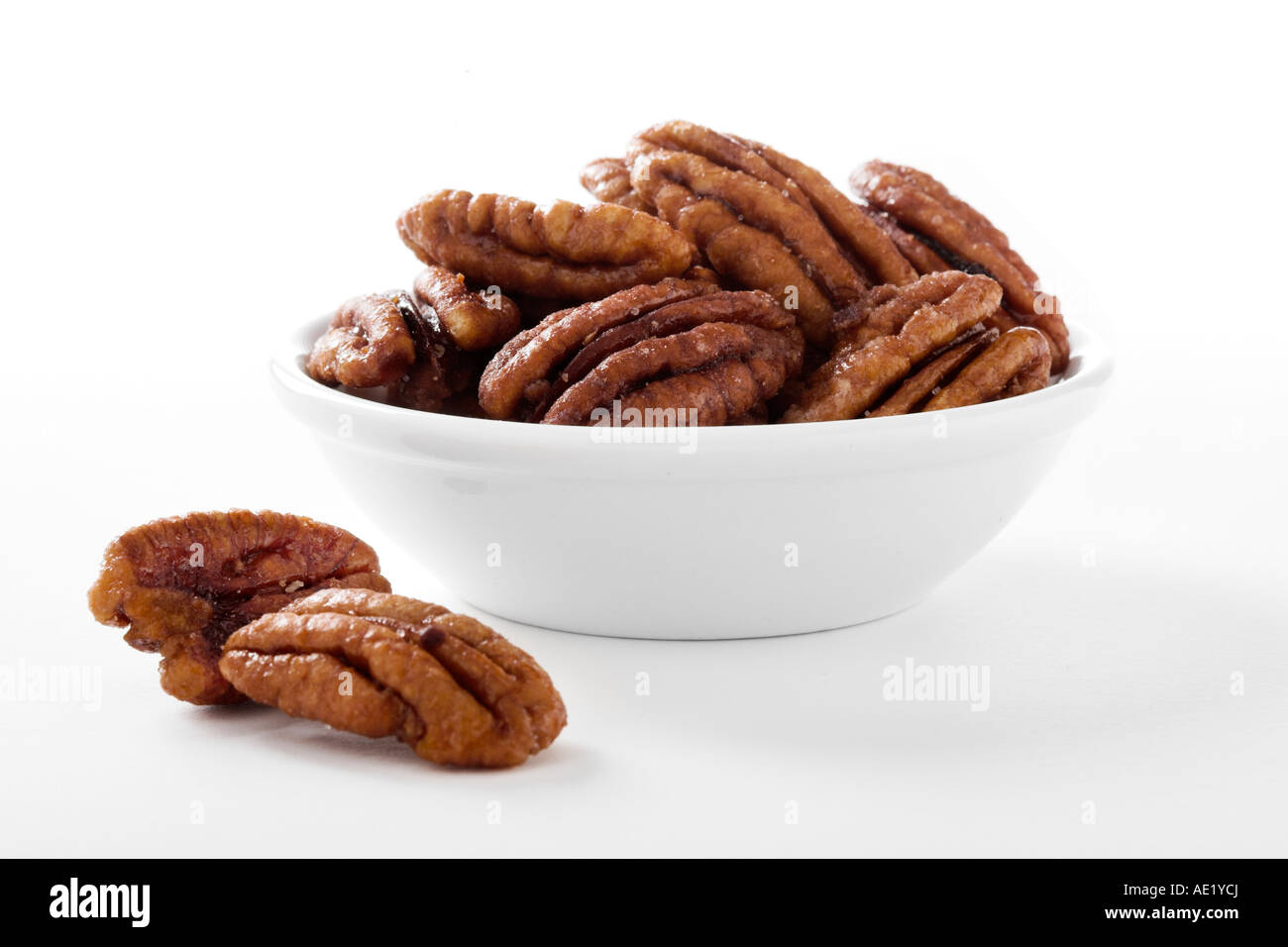 A bowl of candied pecans with white background cutout Stock Photo