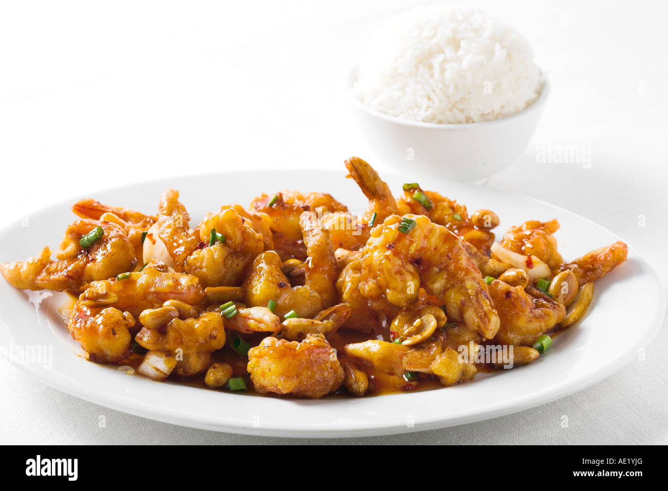 Kung Pao pau shrimp prawn spicy oyster sauce chinese food with green onion dish white plate delicious mouth watering savory Stock Photo