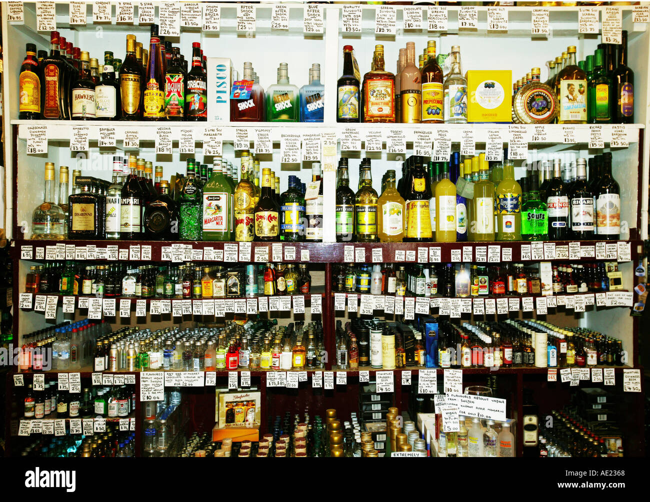 spirits bottles on shelves in a shop Stock Photo Alamy