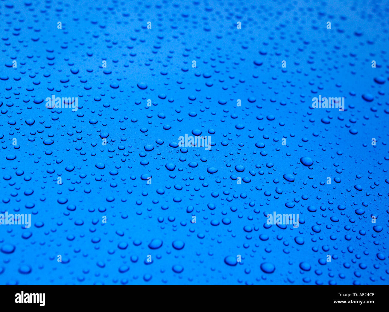 WATER DROPLETS ON BLUE METALLIC SURFACE Stock Photo - Alamy