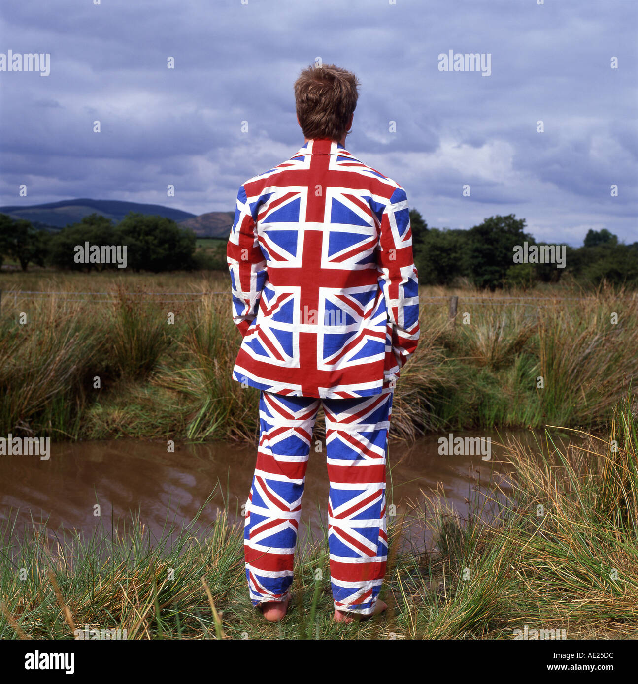 Man wearing Union Jack clothing suit in a rural landscape Wales UK   KATHY DEWITT Stock Photo