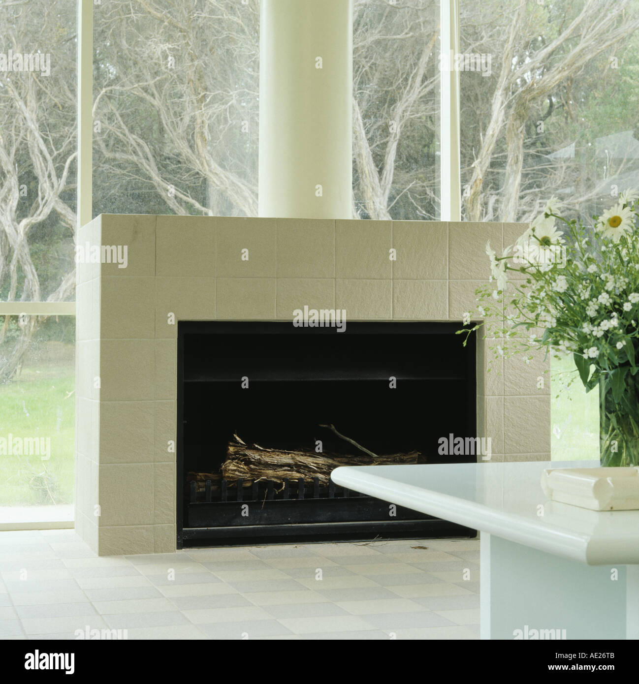 White Matt Tiled Fireplace In Glass Wall Of Modern Dining Room