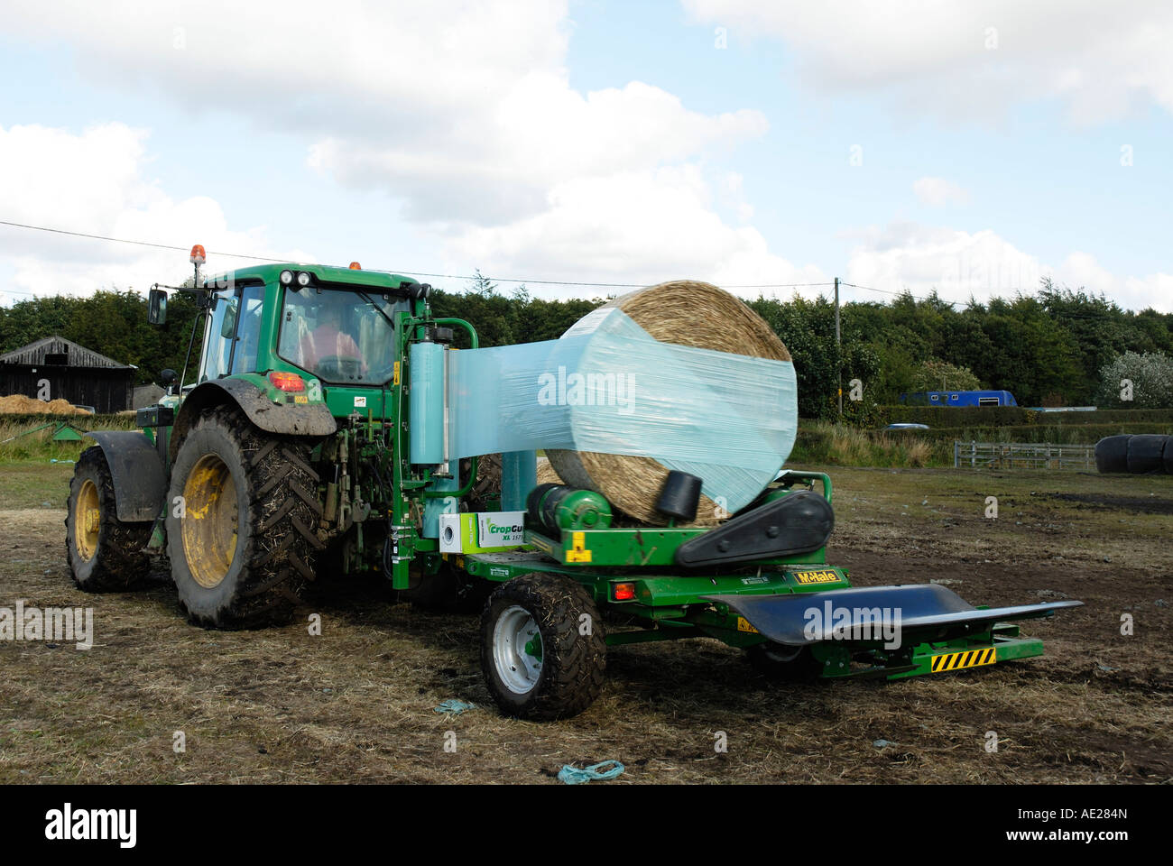 Wrapping round bales of hay for Haylage Stock Photo Alamy