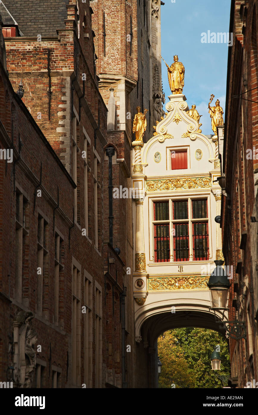 Blinde Ezelstraat archway into Burg Square topped with gold figures between Town Hall and Civic Registry Bruges Belgium Stock Photo