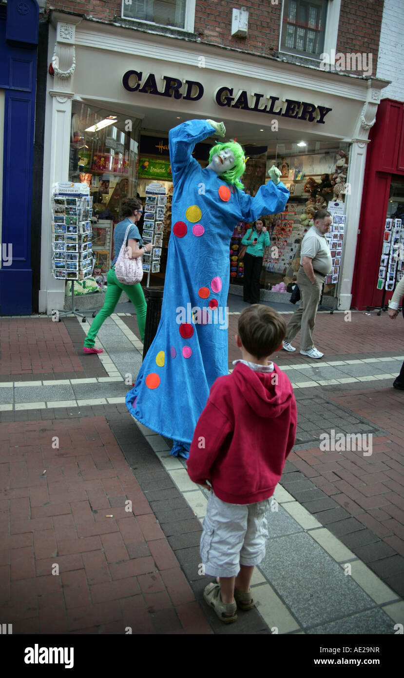 small boy entranced by lady street entertainer Stock Photo