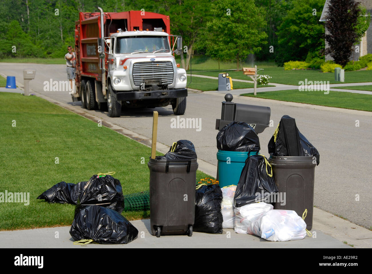 Residential trash collection crew pick up waste products Stock Photo