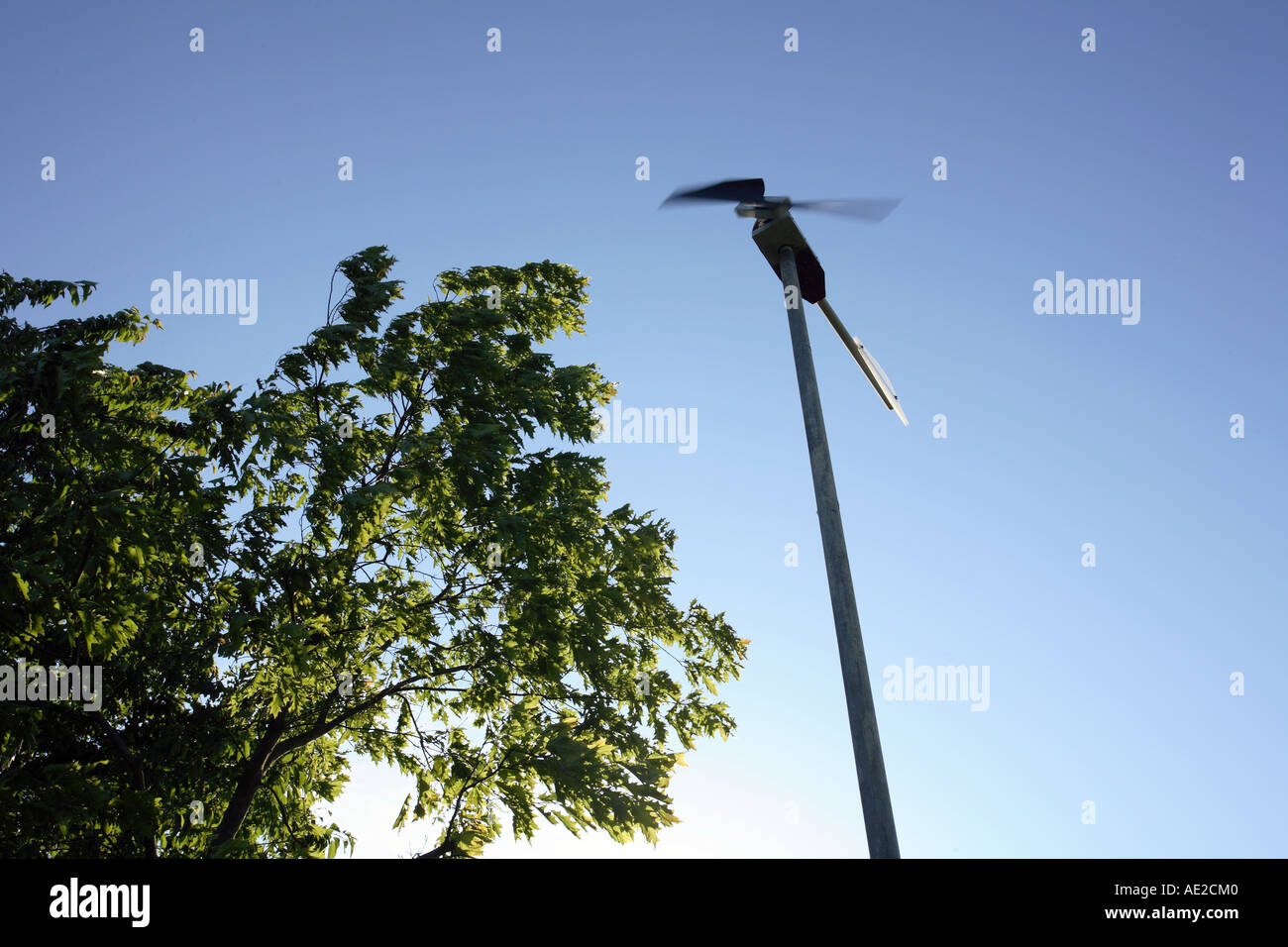 Micro wind turbine, A small domestic wind generator powering low voltage lighting in farm buildings, Hampshire, England. Stock Photo