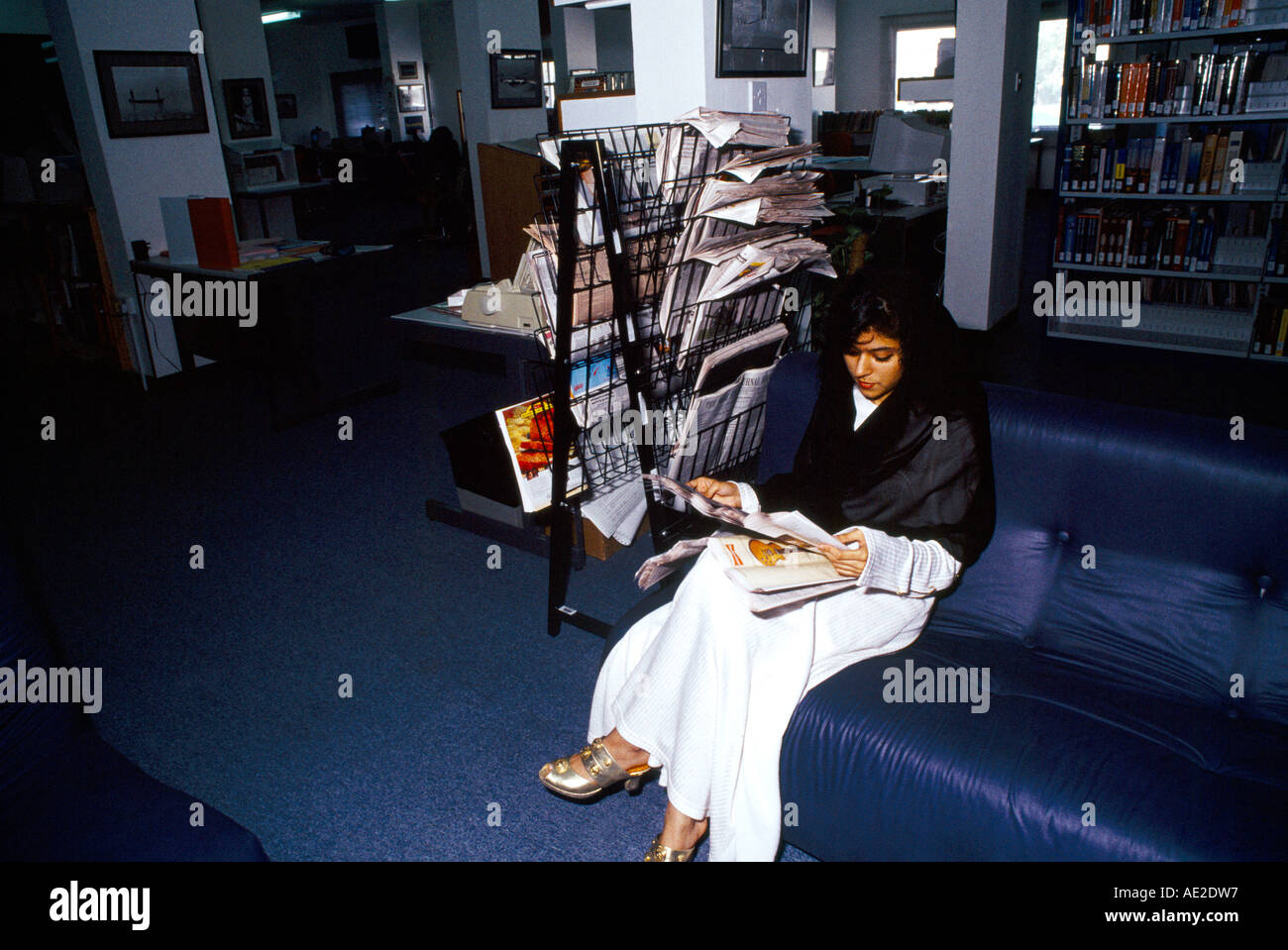 Abu Dhabi UAE Womens College Library Woman Reading Paper Stock Photo