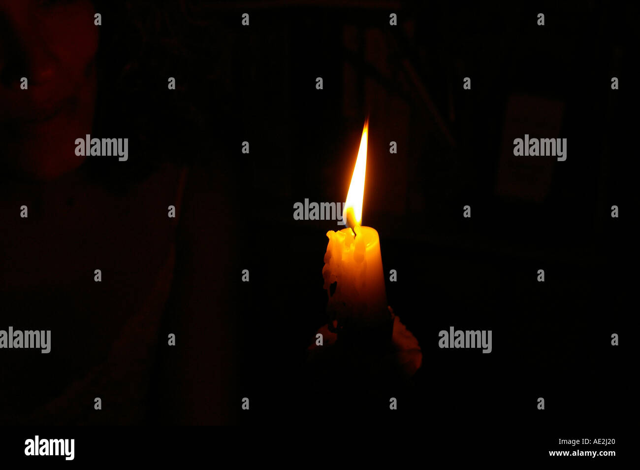 Candle flame light woman in darkness Stock Photo