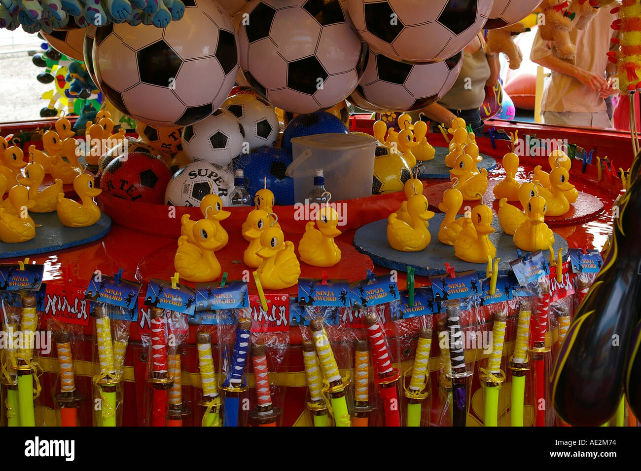 funfair fun fair fairground ground stall toy win rubber duck hook football game Stock Photo