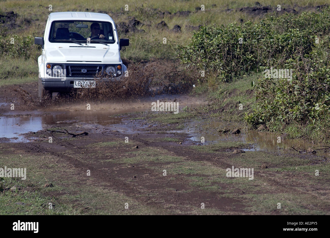 Four wheel drive off road vehicle driving through mud and water on a rough track on Easter Island Stock Photo