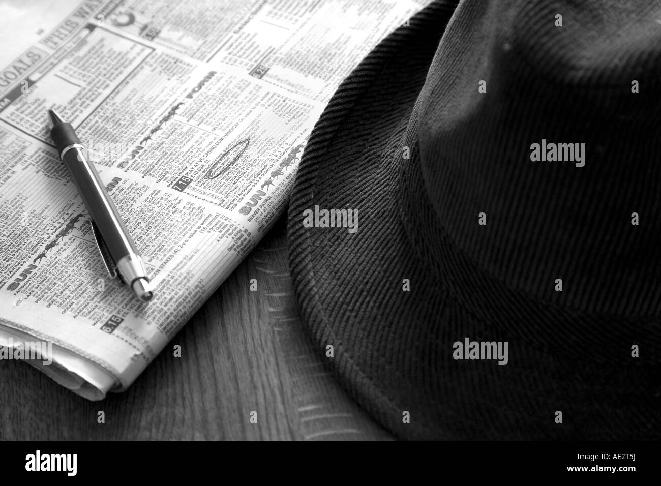 hat newspaper and pen on the horse racing page Stock Photo