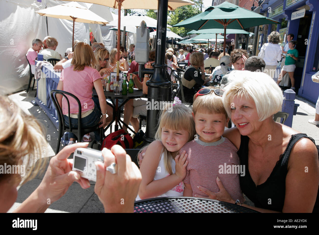 Ann Arbor Michigan,Main Street,Art Fairs,al fresco sidewalk outside outdoors tables,dining,grandmother,child,children,posing,pose,camera,digital,camer Stock Photo