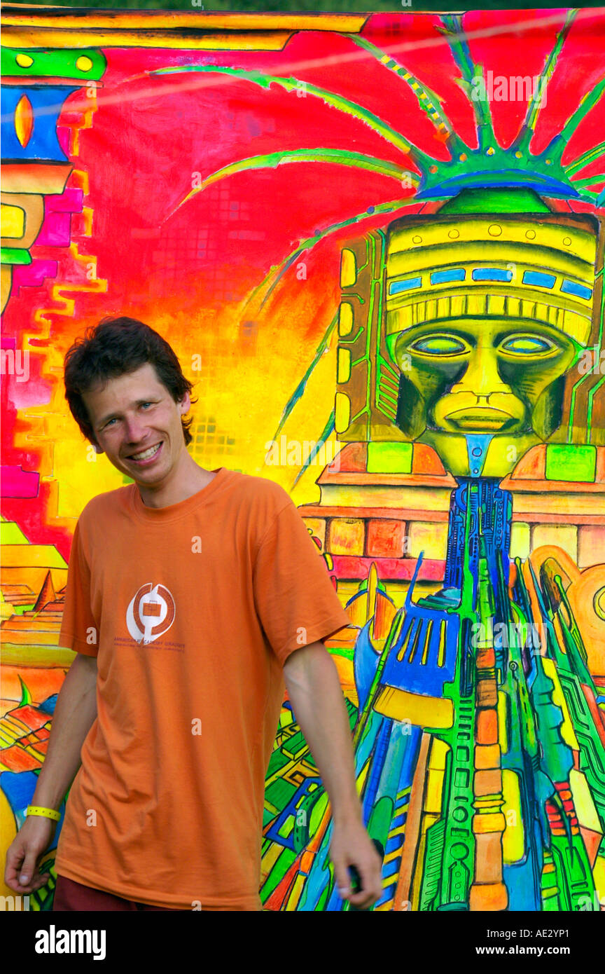 Hilltop 2006 - boy dancing at rave party in front of psychedelic painting, Slovakia Stock Photo