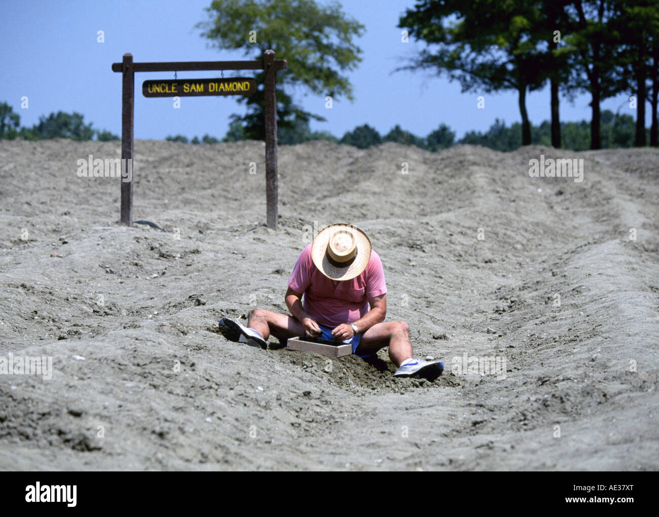 A visiting man digs for real diamonds at Crater Of Diamonds State Park in southern Arkansas Stock Photo