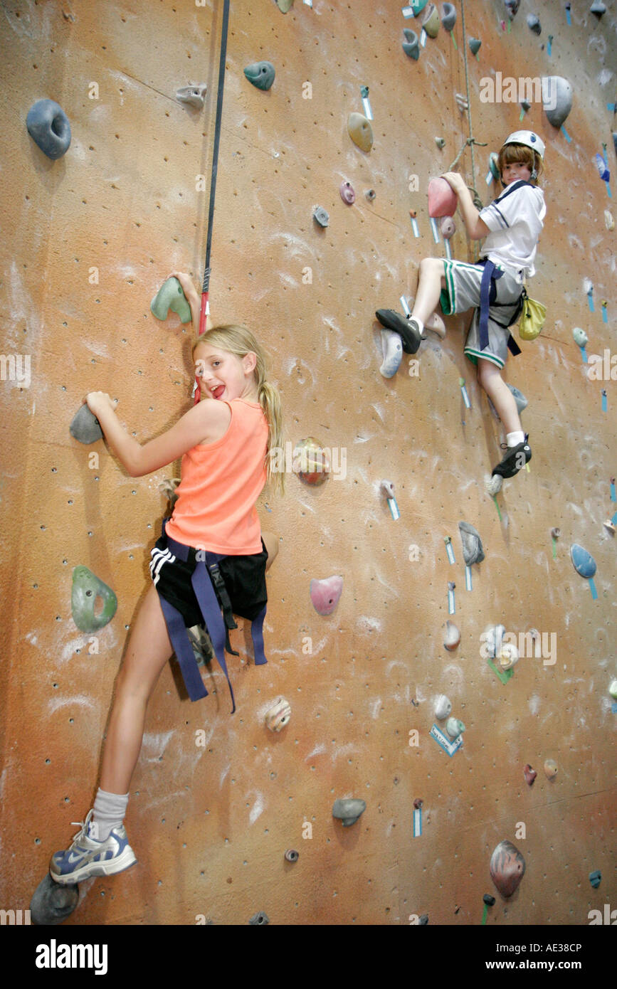 Ann Arbor Michigan,Planet Rock Climbing Gym,girl girls,female kid kids child children youngster,boy boys,male,foothold,handhold,tethered,harness,MI070 Stock Photo