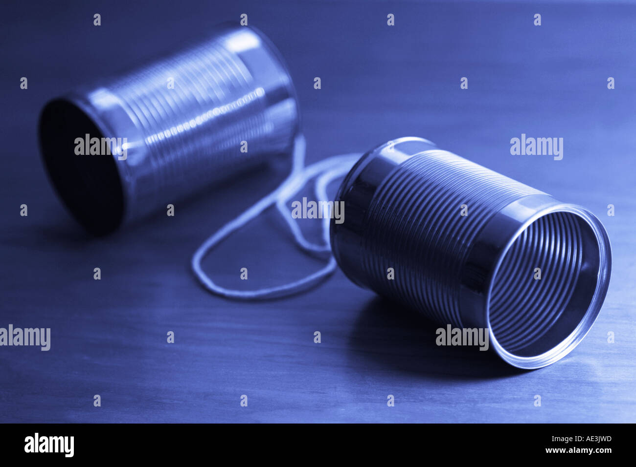 Tin can telephone on wooden desk Stock Photo