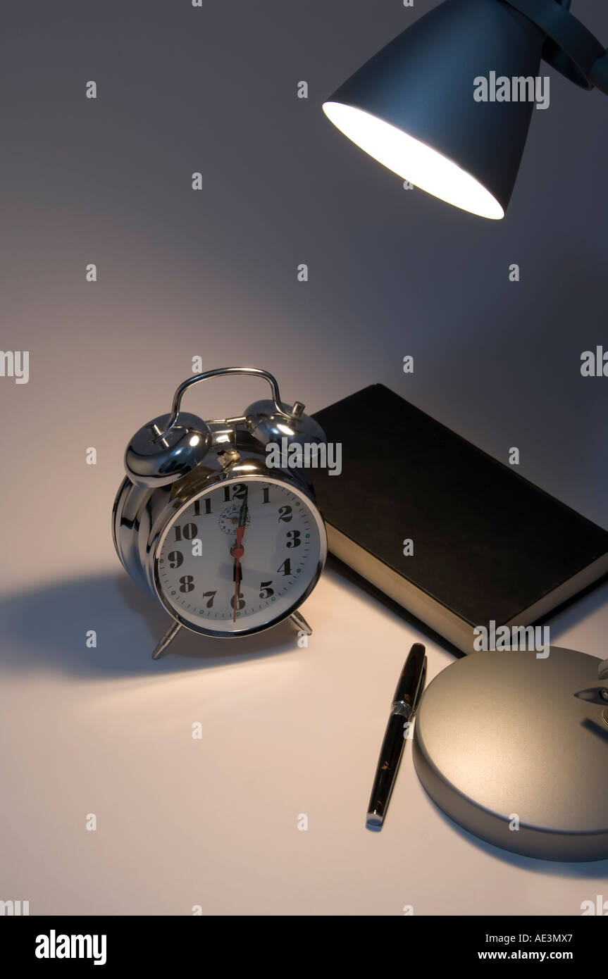 Novel and desk lamp with alarm clock Stock Photo