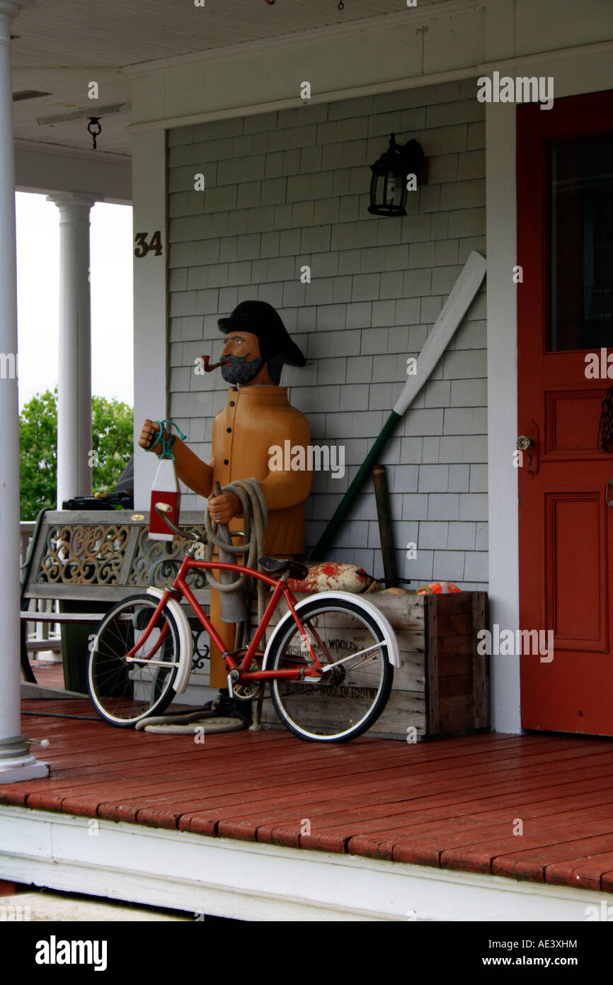 fisherman sculpture and bike displayed on porch of house, Lunenburg, Nova Scotia. Photo by Willy Matheisl Stock Photo