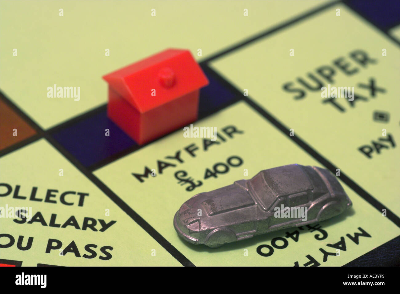 horizontal photo of monopoly game board showing car on mayfair with