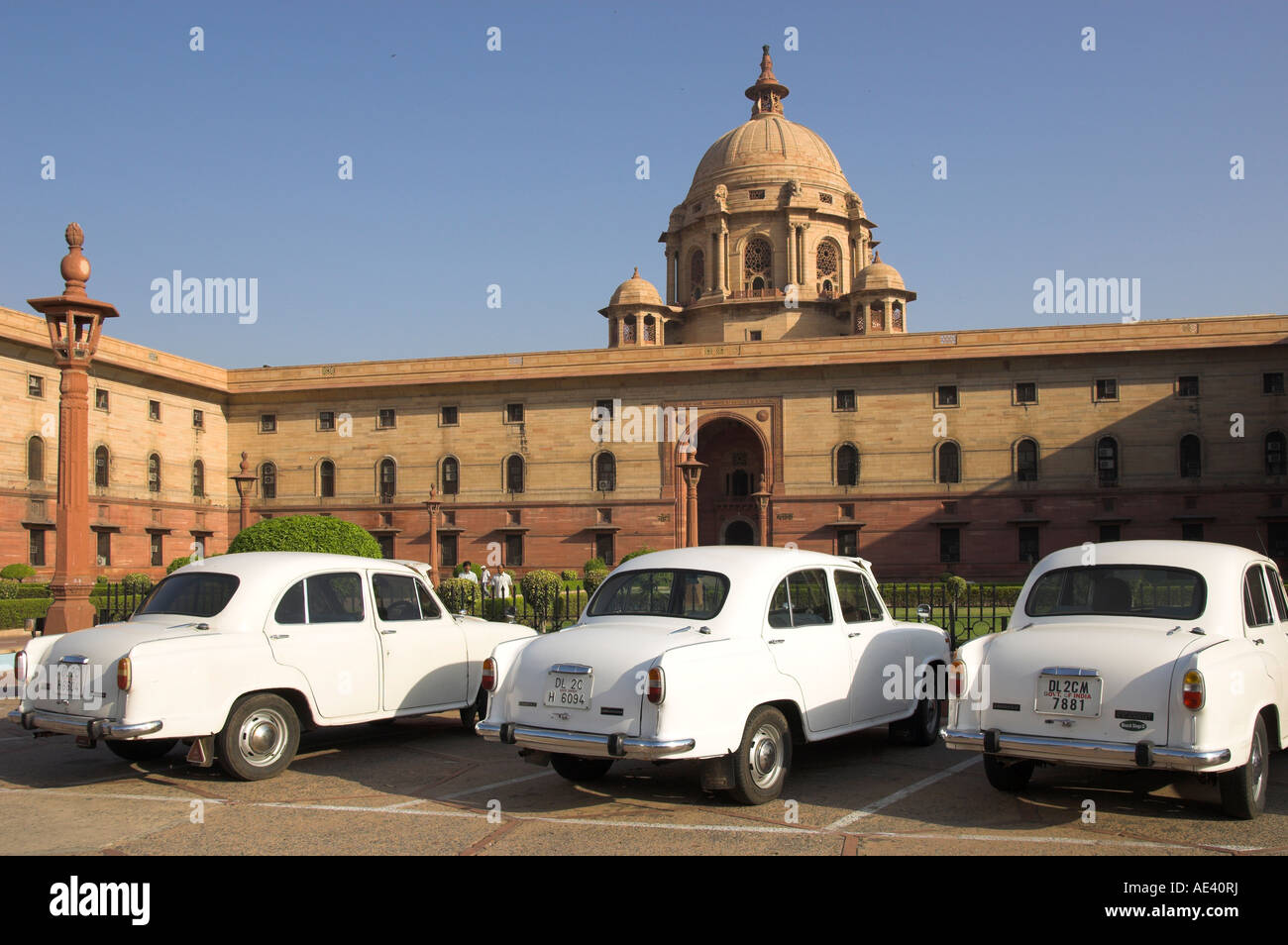 The Secretariats, Rashtrapati Bhavan, with white official Ambassador cars with secretatriat in background, Delhi, India, Asia Stock Photo