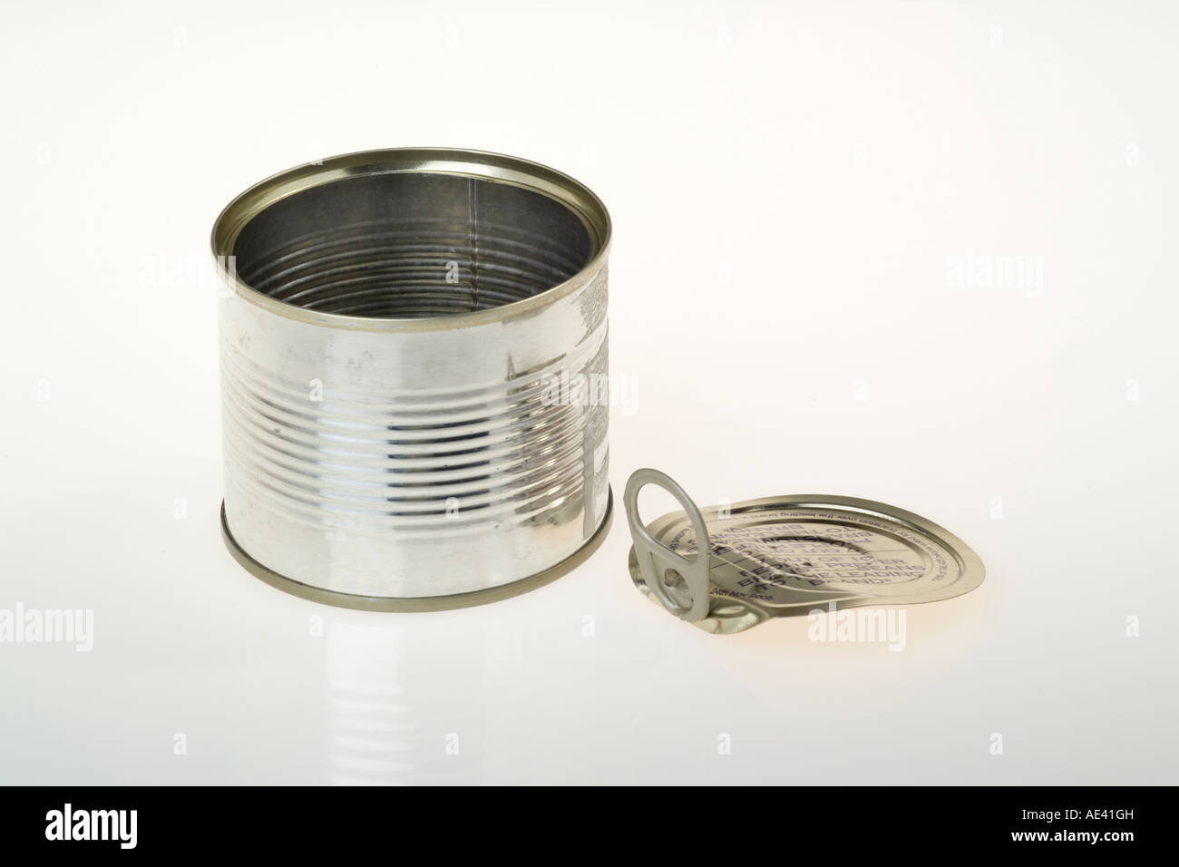 ring pull lid by empty tin can half size Stock Photo