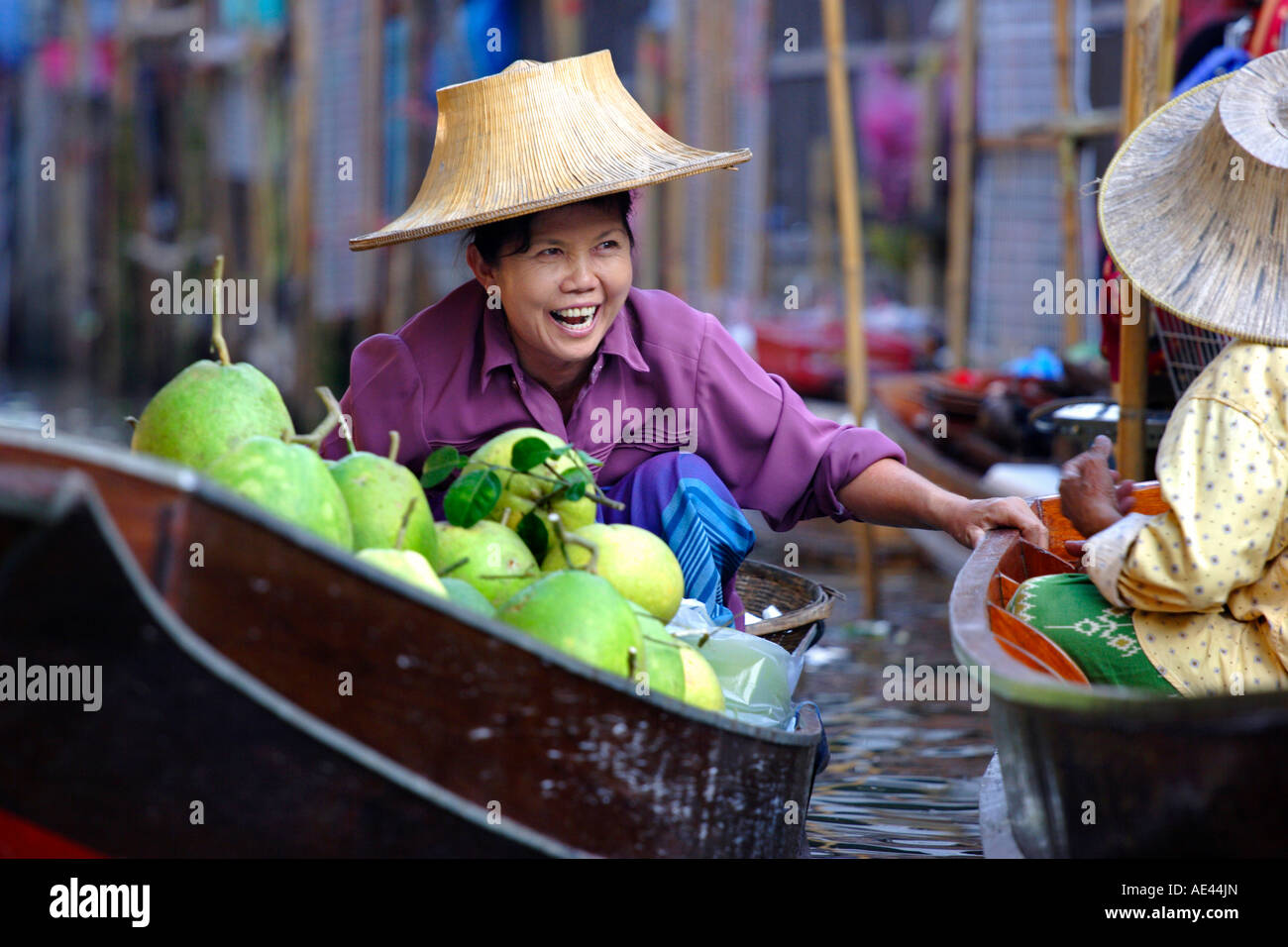 Local women share a joke at Damnoen Saduak Floating Market, Thailand, Southeast Asia, Asia Stock Photo