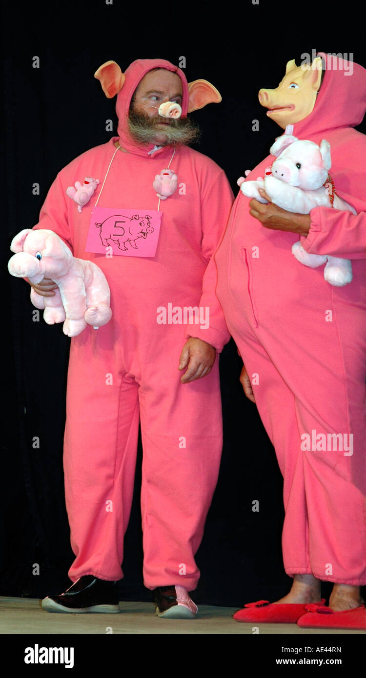 A competing couple zealously performing in the annual Trie sur Baïse pig squealing contest Stock Photo