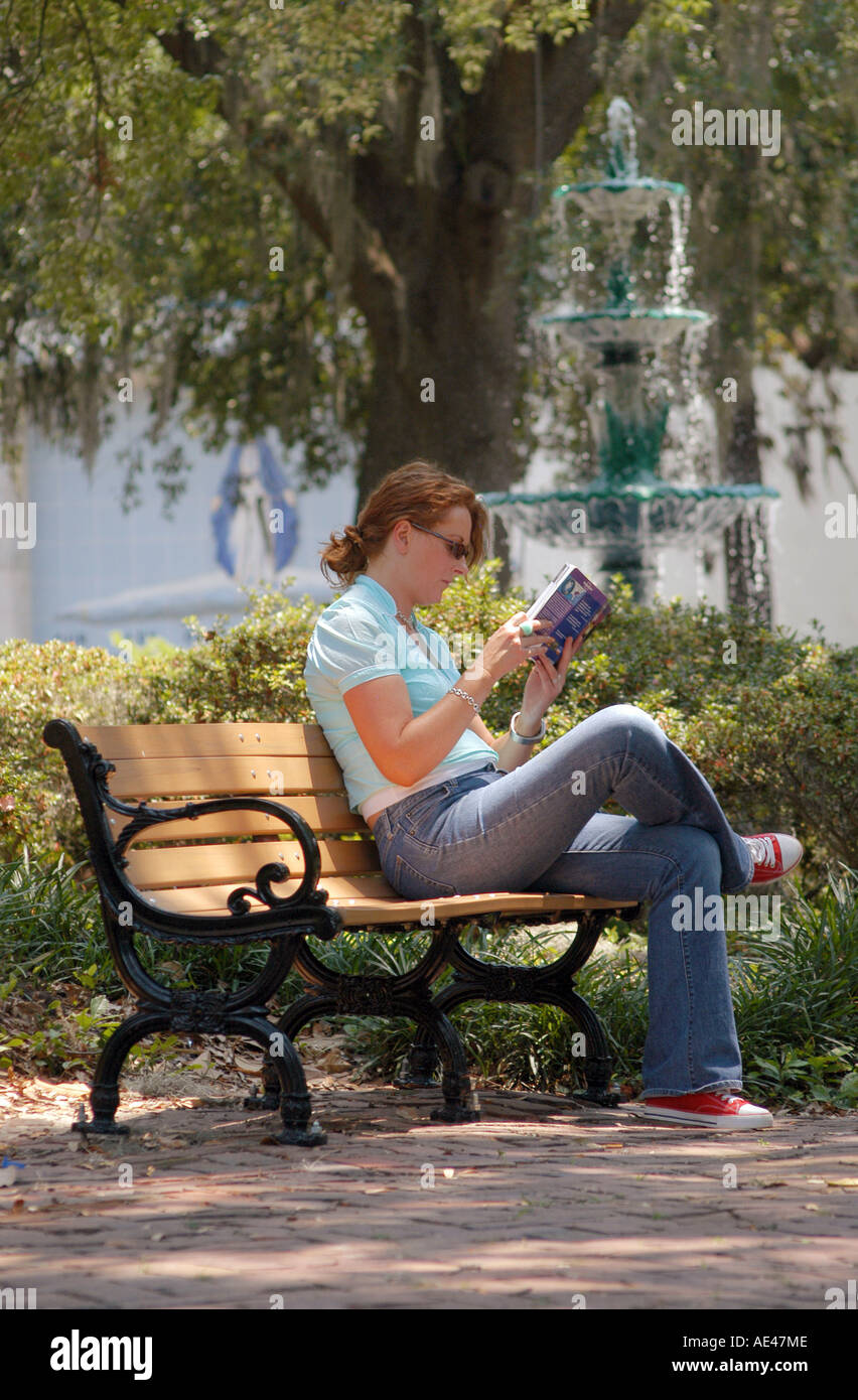 Woman with ginger / red hair reading on a park bench in Lafayette ...