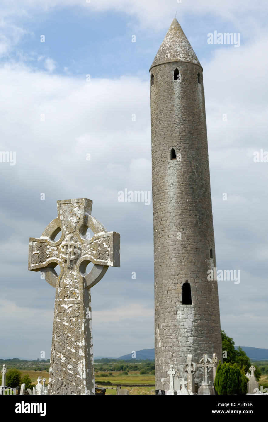 Kilmacdaugh Round Tower and Celtic style cross, near Gort, County Galway, Connacht, Republic of Ireland, Europe Stock Photo