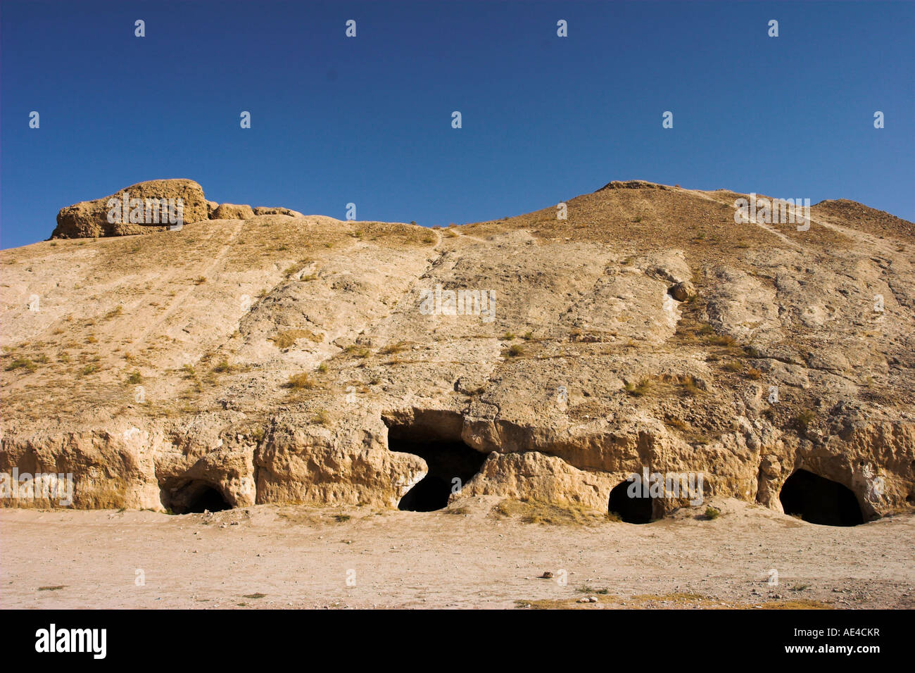 Buddhist caves, living quarters, stupa-monastery from Kushano-Sasanian period, Takht-I-Rustam, Samangan Province, Afghanistan Stock Photo