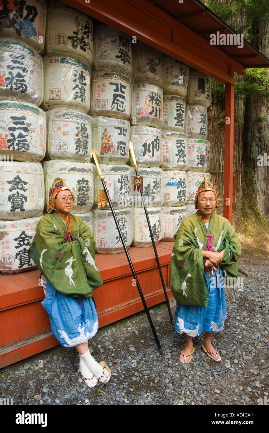Men traditional clothing in front of colourful sake barrels, Nikko Festival, Toshogu Shrine, Nikko, Tochigi prefecture, Japan Stock Photo
