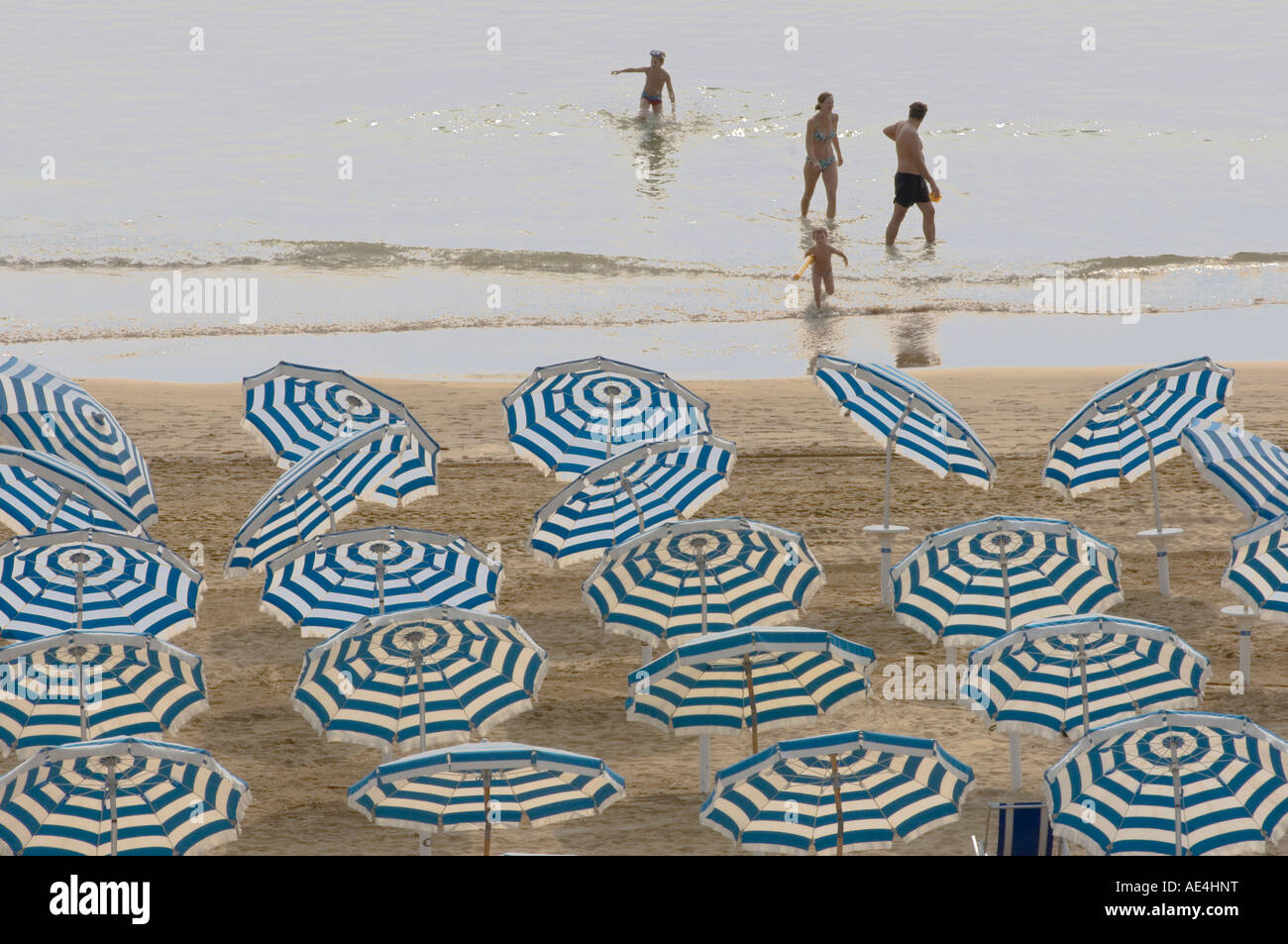 Umbrellas on the beach, family in the sea, Jesolo, Lagoon
