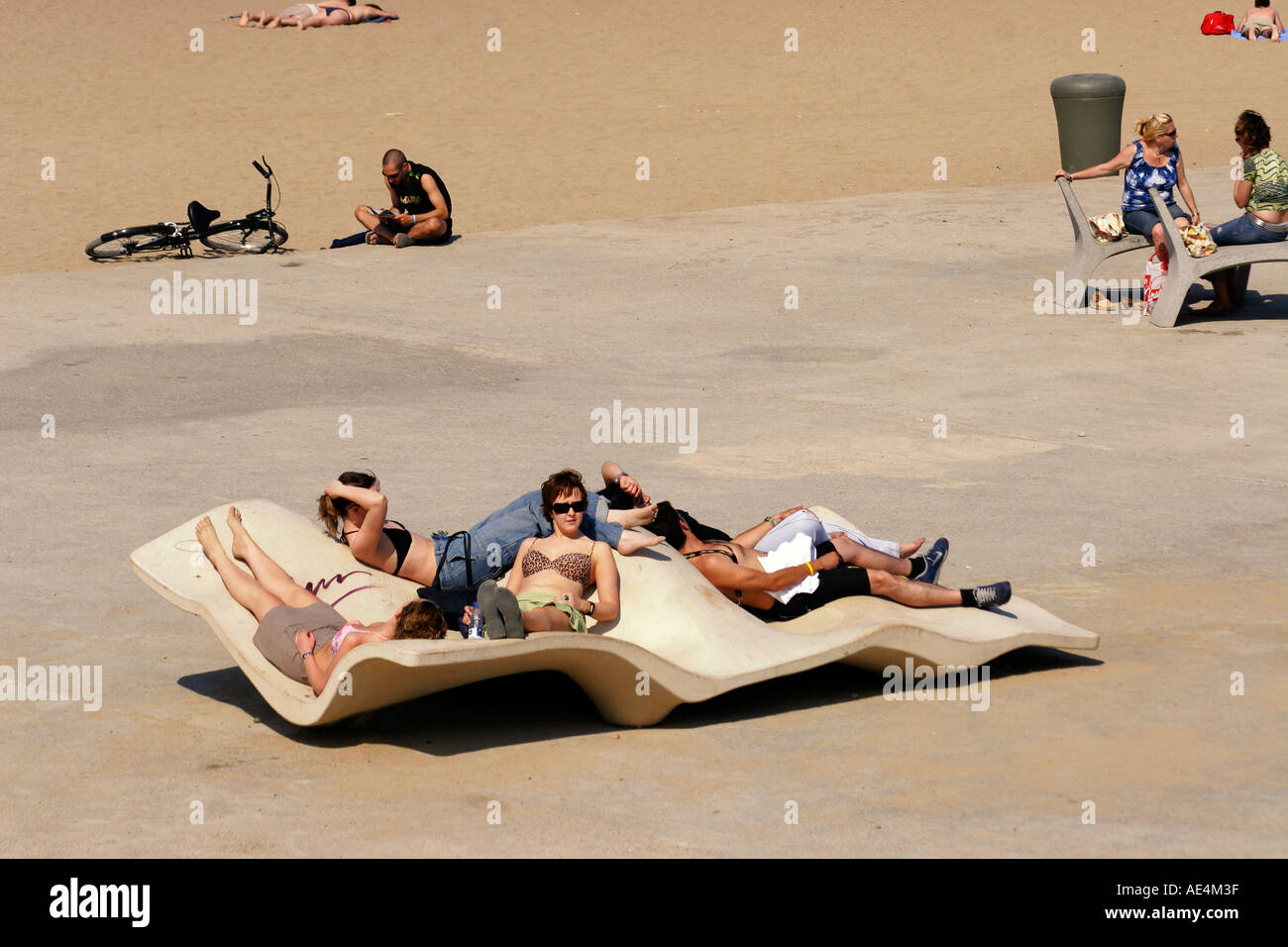 Spain Barcelona beach Platja de la Barceloneta curved seats for sunbathing Stock Photo