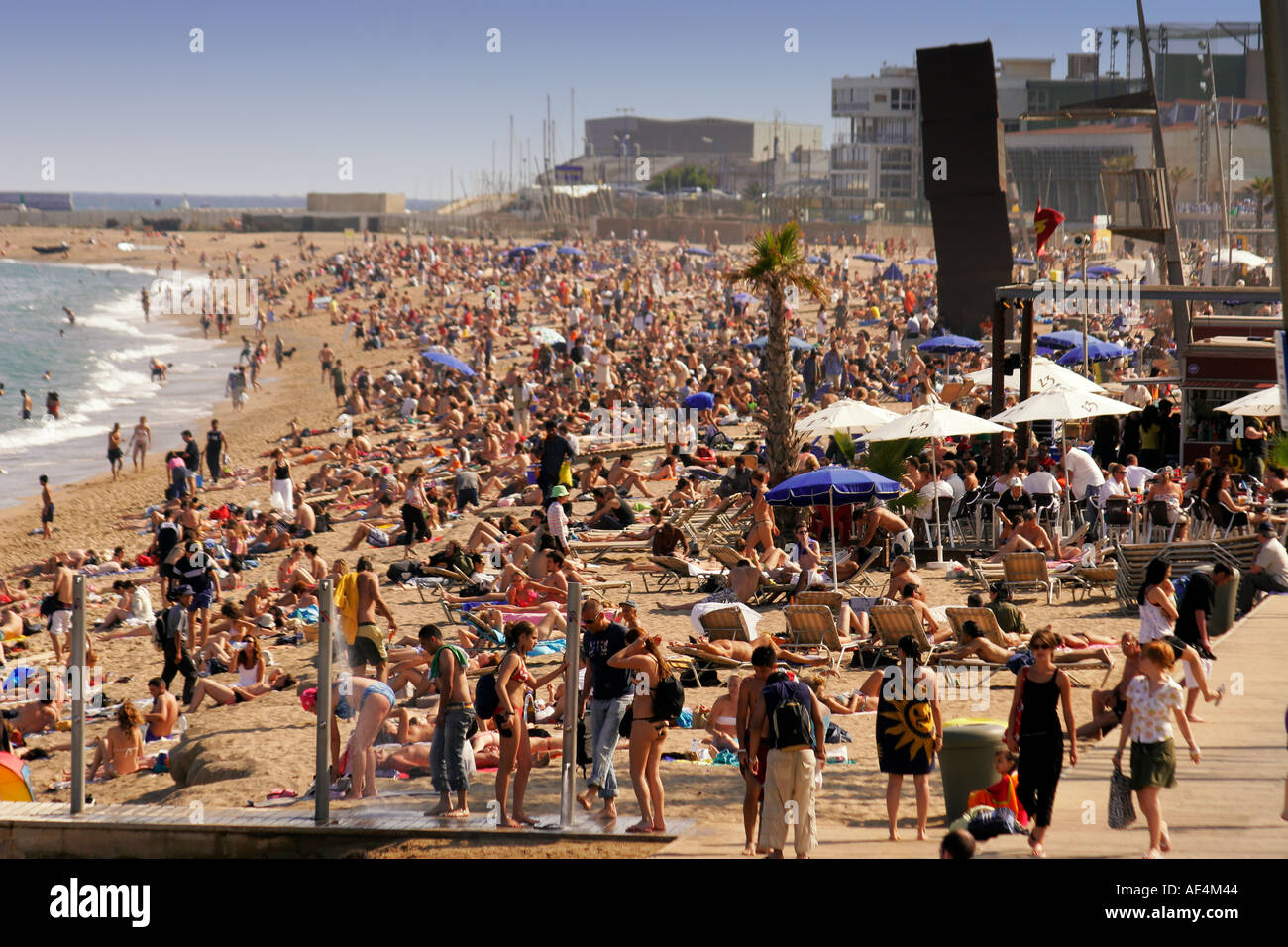 Spain Barcelona crowded beach Platja de la Barceloneta people Sculture by Rebecca Horn  Stock Photo